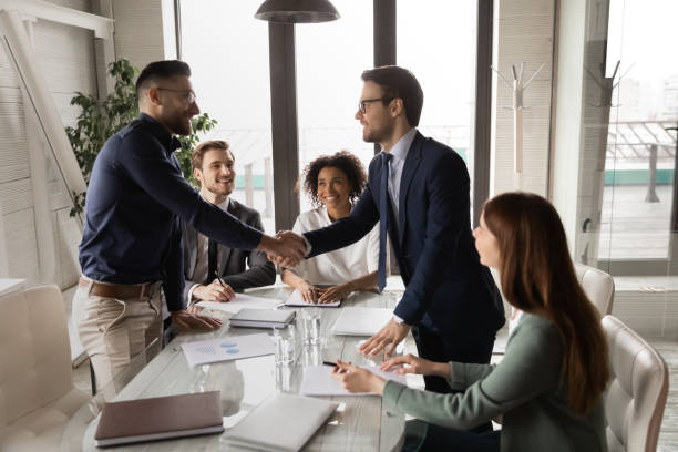 istock Two male confident partners shaking hands, establishing profitable cooperation. 1286549421