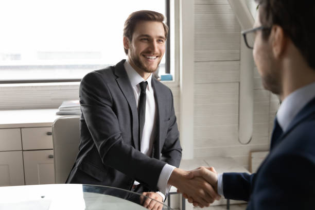 istock Happy two businessmen celebrating making agreement in office. 1286549424