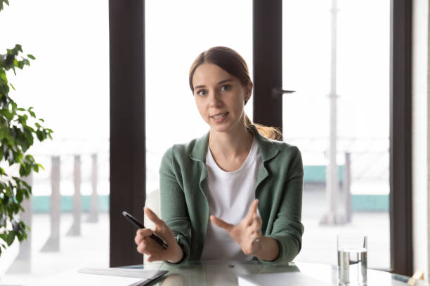 istock Web camera view young businesswoman discussing project online. 1286549452