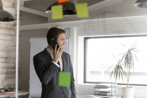 istock Young ceo executive manager holding mobile phone business call. 1286549477