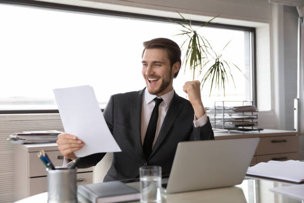 istock Euphoric young happy businessman celebrating professional achievement. 1286549492