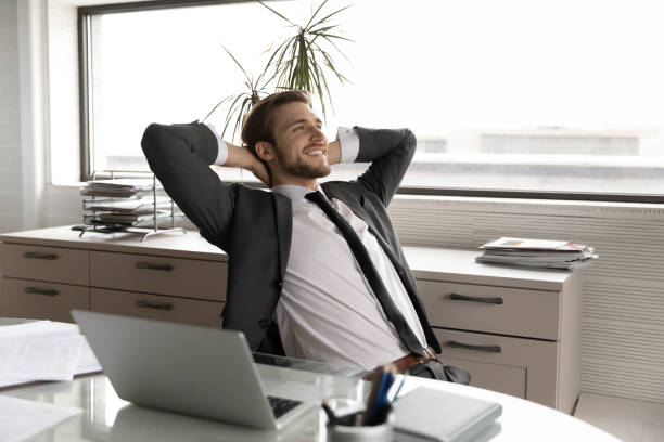 istock Relaxed young happy businessman enjoying break time. 1286549497
