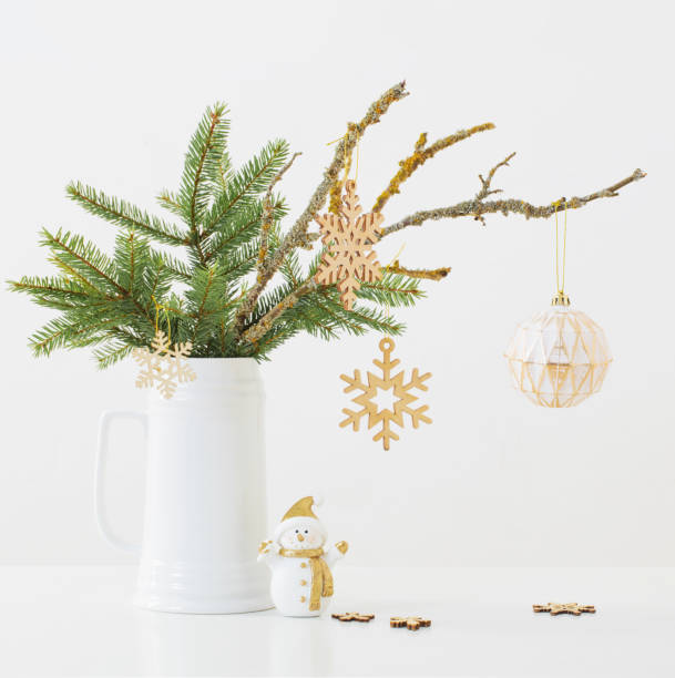 istock modern Christmas sill life in jug with snowman on white background 1286549583