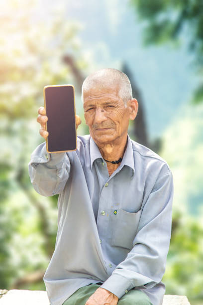 istock Indian Rural Old Man Showing mobile phone 1286549740