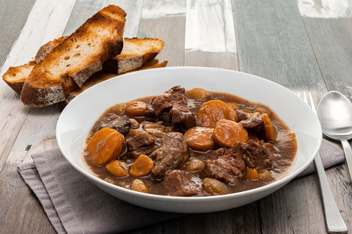 Beef in red wine stew with toasted rustic bread