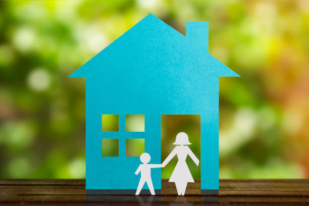 istock Single Mother With son in paper wit blue house. Divorced. 1286550390