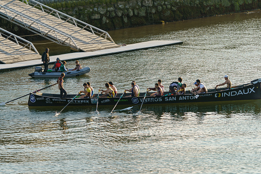 Zumaia, Spain - June 12, 2019: Spanish rowing school. The team trains on the River. Sports healthy lifestyle concept.