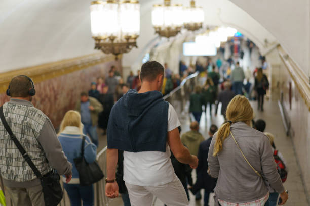 Moscow, Russia - August 8, 2019: Image of people in the Moscow metro during rush hour. Backs / rear view. Lifestyle concept.