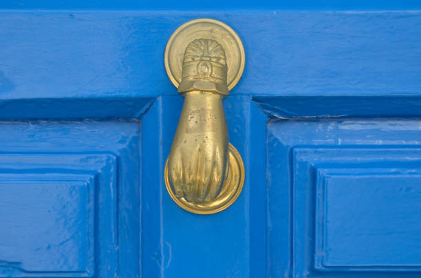 istock Old metal door handle knocker on wooden background 1286553613
