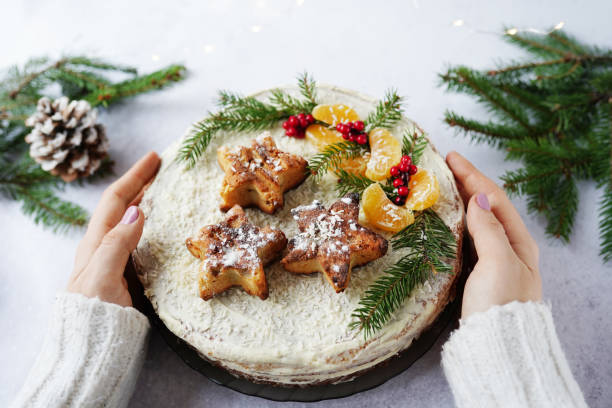 Girl hands holding a beautiful Christmas cake, winter food
