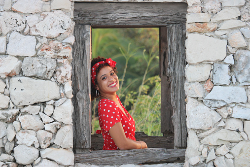 Cuban young woman in the window