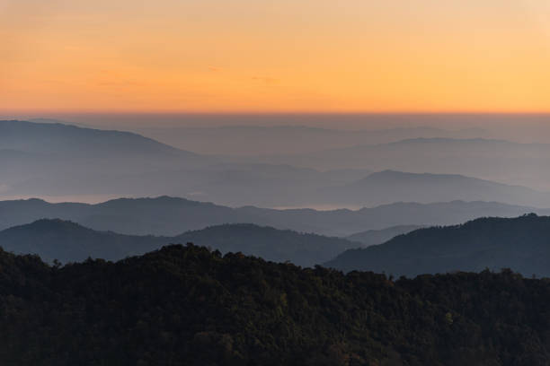istock Sunrise in silhouette mountain range from above view 1286558868