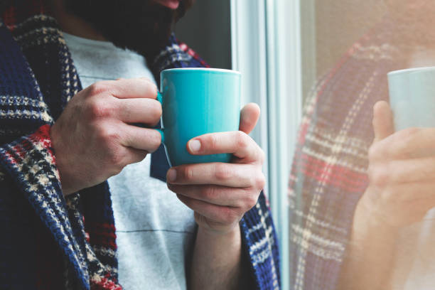 istock Hand of man holding a coffee cup 1286560031