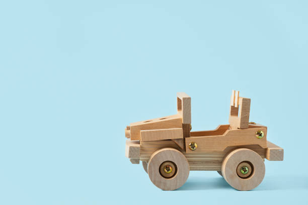 istock Wooden car toy on blue background with copy space for text. 1286560136