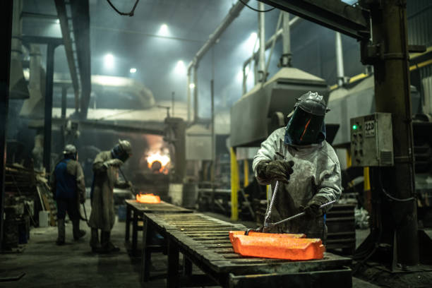 istock Metal industry work - removing hot iron using tweezers 1286564319