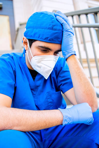 istock Serious, crestfallen, overworked, male health care worker 1286564608