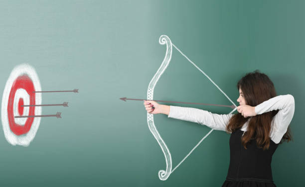 istock Pre-adolescent girl holding painted bow and arrow 1286565618
