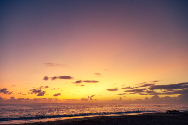 istock Dramatic sea shore sunset with sun setting down at the cloudy skyline with orange and vivid blues. 1286565958