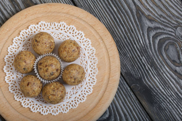 istock Dried fruit and oatmeal sweets. On black pine boards. Close-up shot. 1286567400