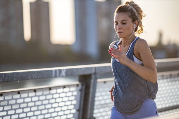 istock Woman jogging on the bridge 1286567521