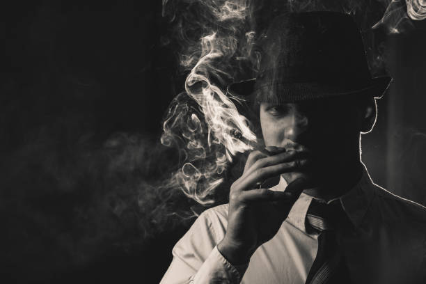 istock Retro man in tie and hat smoking 1286568707