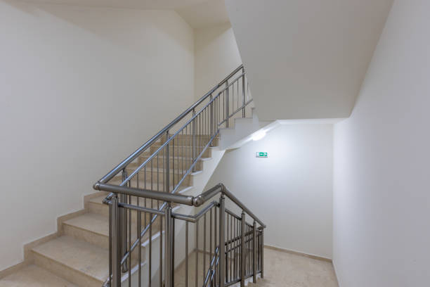 istock Modern stair case between floors. Stairs with metallic rail  in modern building 1286568955