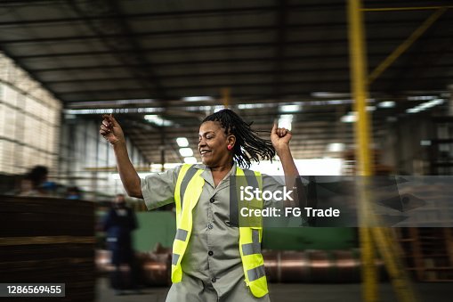 istock Happy mature woman dancing in a industry 1286569455