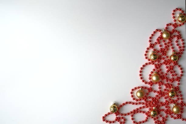 Flatley. Small red beads and golden balls. New year and christmas theme.