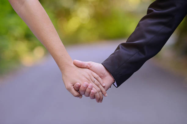 istock A married couple holding hands with the road in the background 1286572326