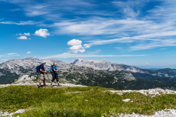 istock Mature couple hiking mountains against blue sky 1286573523