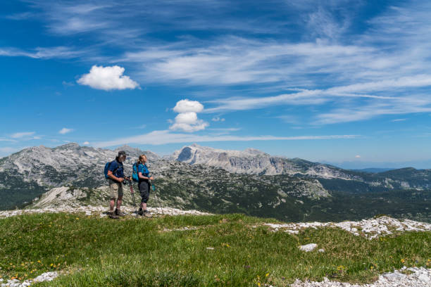 istock Mature couple hiking mountains against blue sky 1286573575