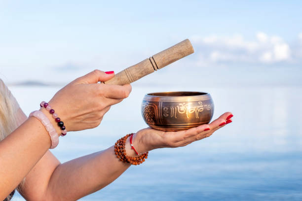 istock Tibetan singing bowl in female hands on nature background 1286574693