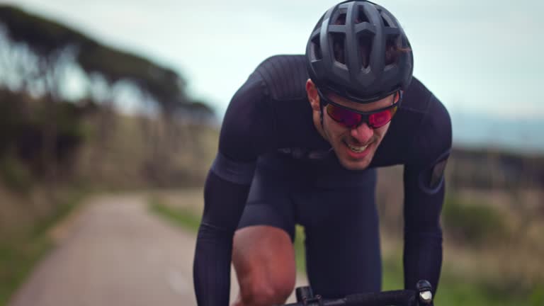 Professional cyclist struggling to ride bicycle during training