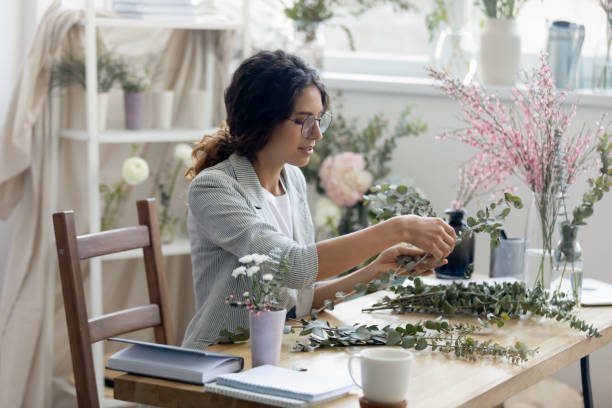 istock Creative woman florist arrange floral compositions at desk 1286575721