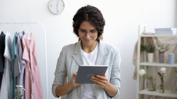 istock Happy female designer browse internet on tablet 1286575912