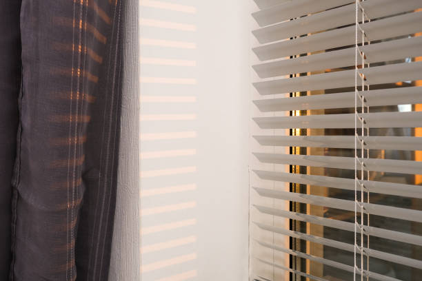 istock Blinds on a window in a bedroom with morning sun rays and beautiful light at waking up, getting up moment 1286576037