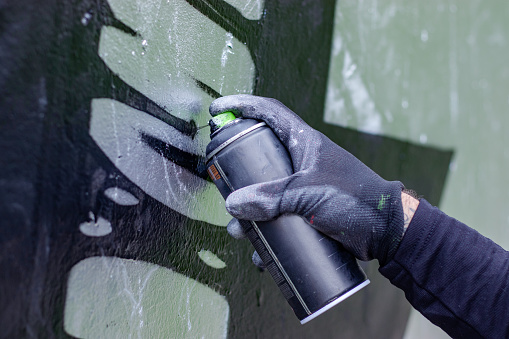 Graffiti Artist Drawing Graffiti on Wall.