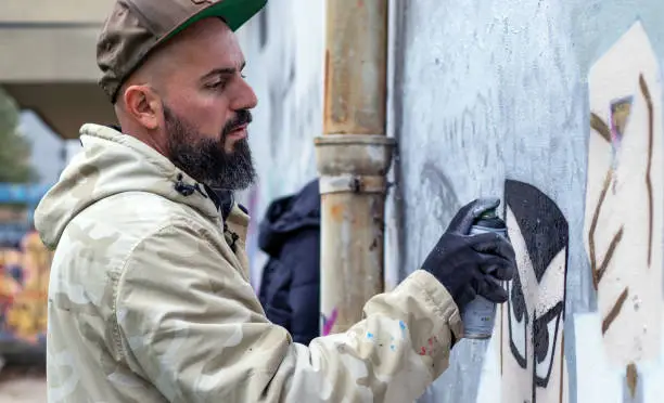 Photo of Graffiti artist in action.