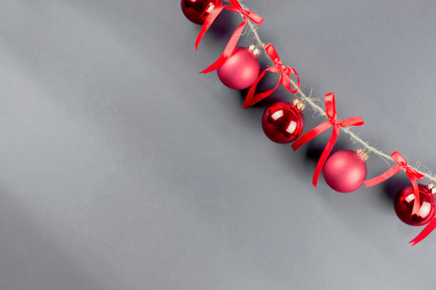 istock thread with red christmas balls and red bows on black background 1286576531
