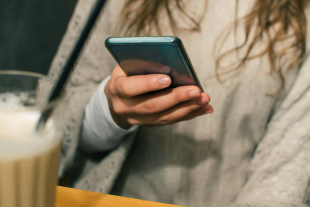 istock Woman holding and using mobile phone stock photo 1286576554
