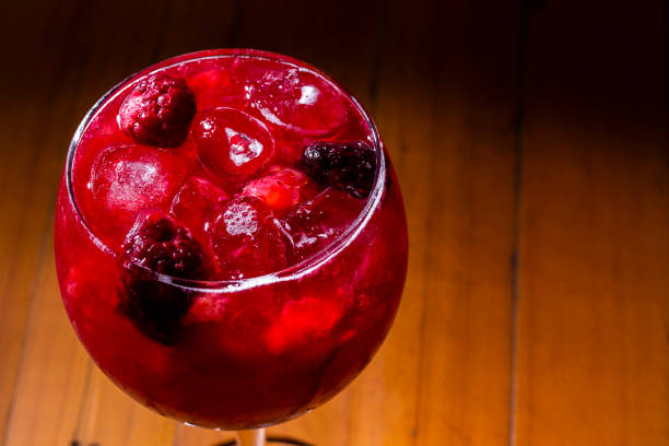 istock Gin and red fruit cocktail on wood background. London Dry Gin. 1286577322
