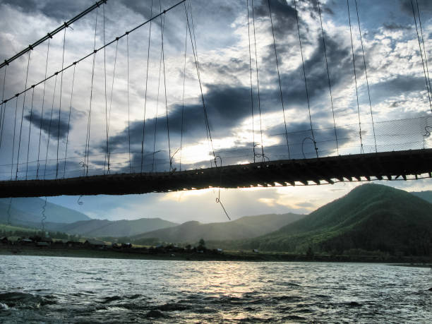 istock hinged wooden bridge over the river somewhere on the altai. 1286582095