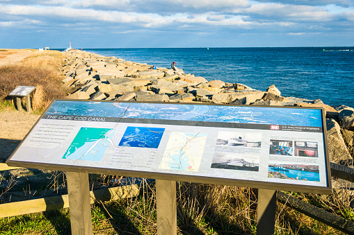 Scusset Beach, Massachusetts, USA-November 18, 2020- A pair of information signs at the eastern end of the Cape Cod Canal educate visitors on the specifications and  history of the Canal.