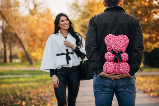 istock Rear view of young man hiding present from his girlfriend 1286583635