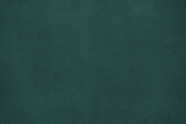 istock Leather texture background surface. Close-up, toned in Tidewater Green, colour 2021. 1286583849