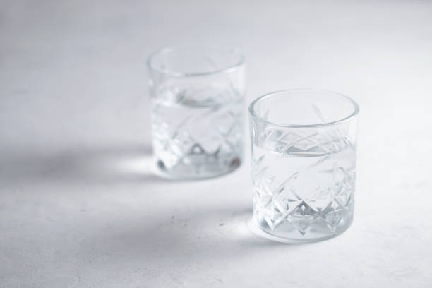 istock Two glasses of water on the table 1286584588