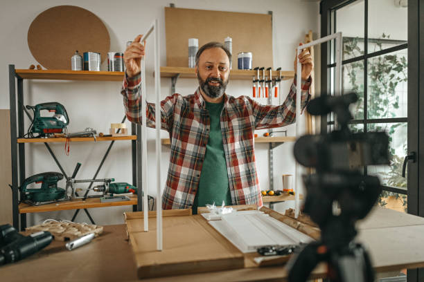 istock Mature man vlogging about how to make shelf by your own 1286589707