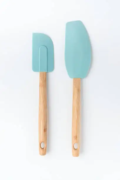 Silicone mixer and scraper Spatula with bamboo handle on a white background