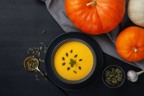 istock Vegetarian autumn pumpkin cream soup with seeds. Top view with copy space 1286593994