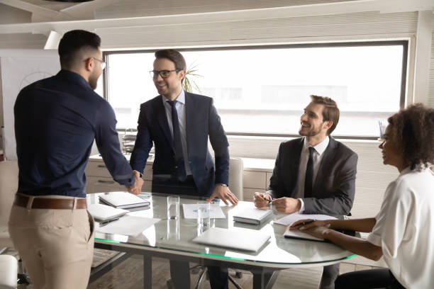 istock Happy 30s caucasian businessman shaking hands with arabian partner. 1286594048